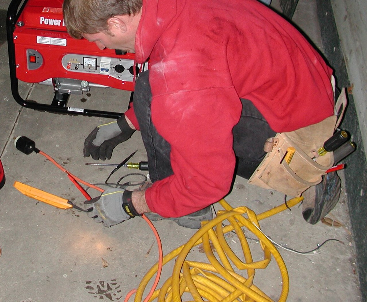Electrician's hands wiring an electrical panel